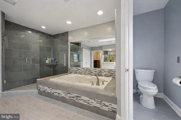 a bedroom with a bed and a large mirror