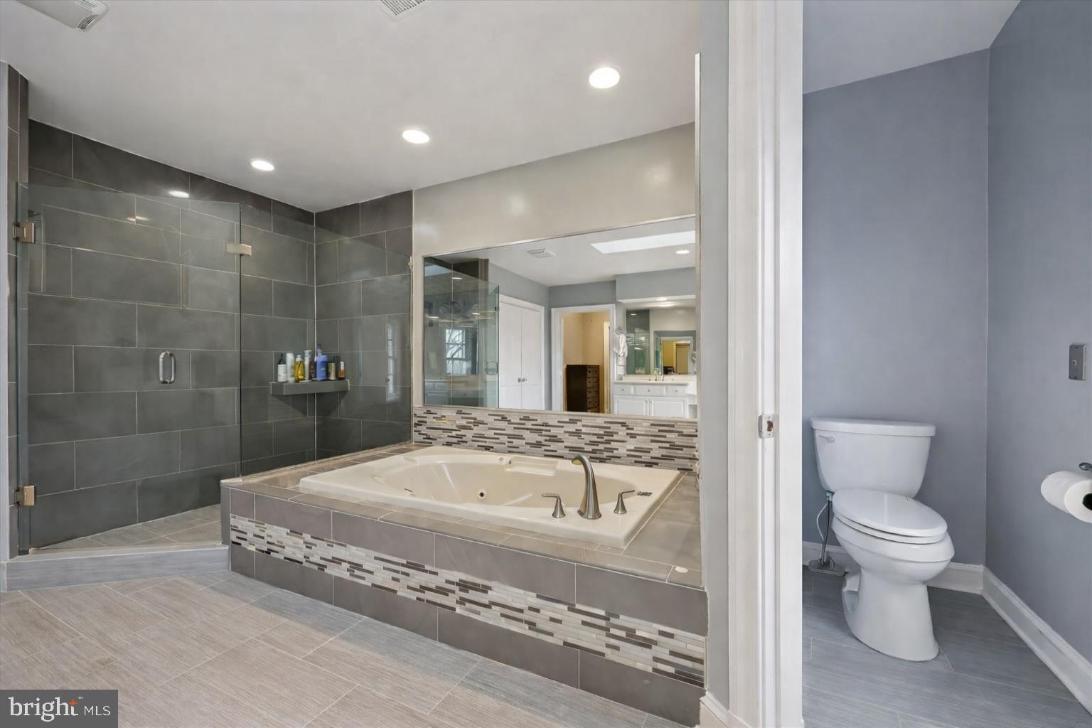 9917 Kendale Road Potomac, MD 20854 - Photo 15 of 39 a spacious bathroom with a granite countertop toilet a sink and bathtub