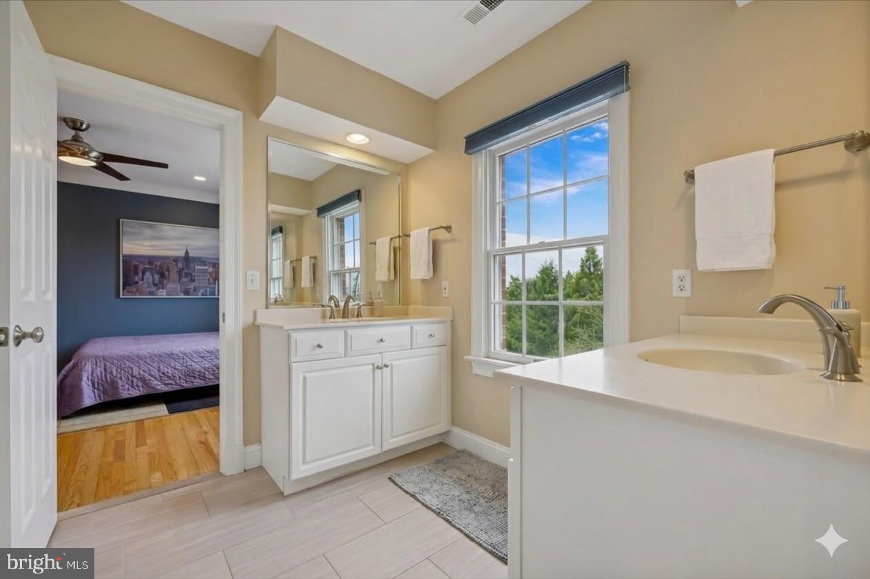 9917 Kendale Road Potomac, MD 20854 - Photo 17 of 39 a bathroom with a granite countertop sink mirror and bathtub