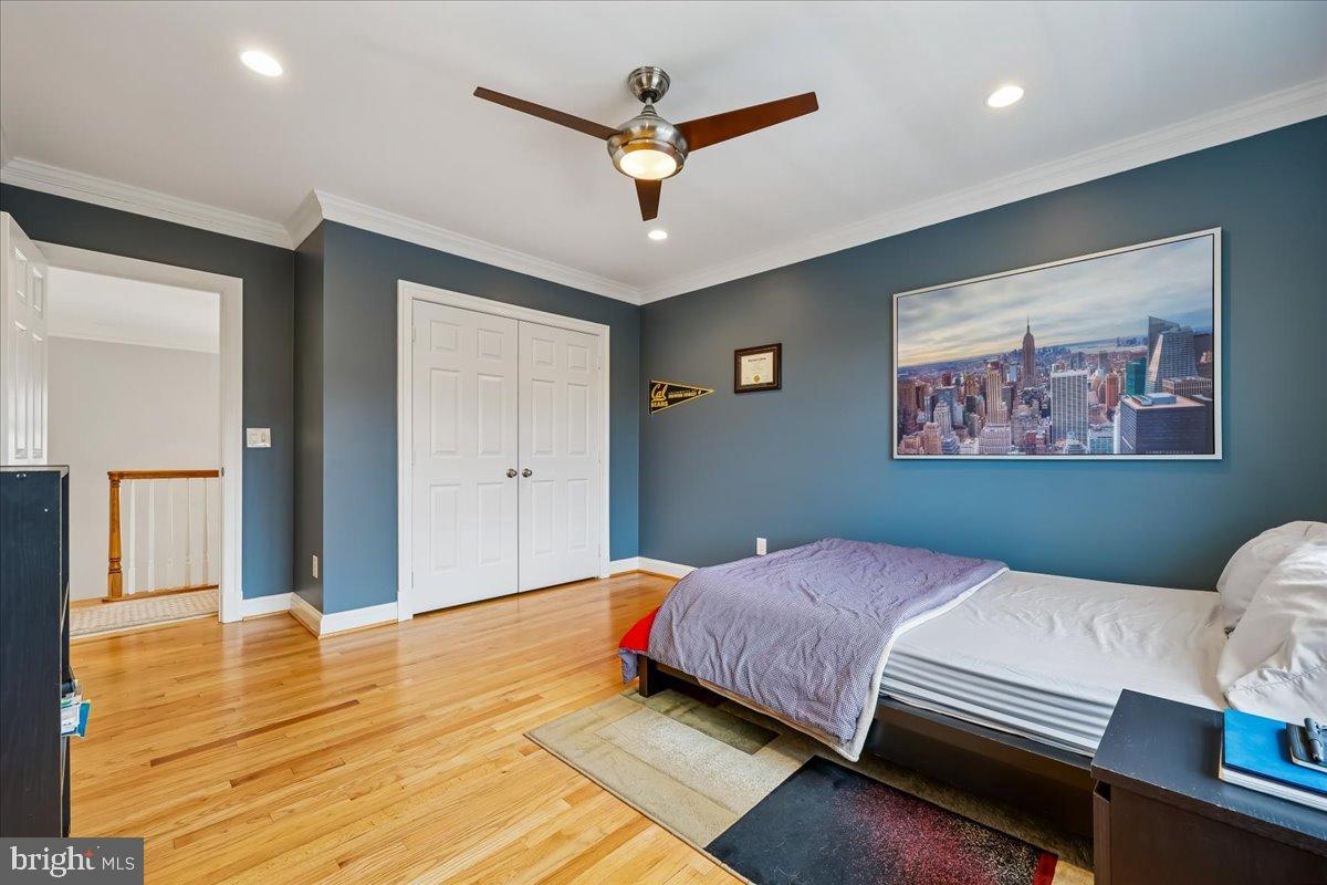 9917 Kendale Road Potomac, MD 20854 - Photo 19 of 39 a bedroom with a large bed and a chandelier