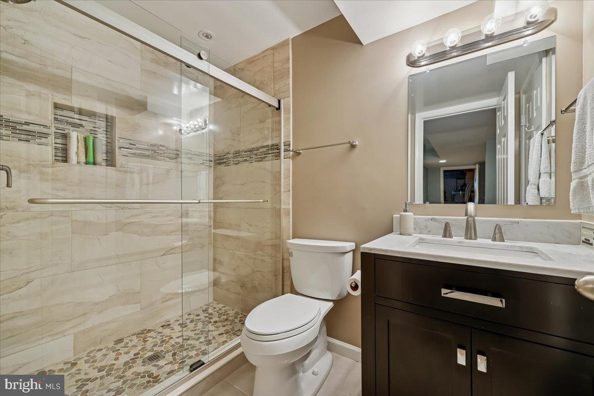 9917 Kendale Road Potomac, MD 20854 - Photo 22 of 39 a bathroom with a sink a toilet and shower