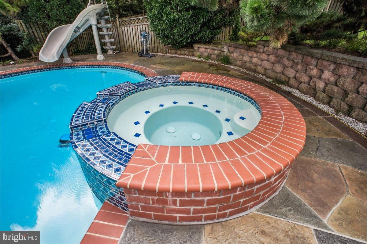 9917 Kendale Road Potomac, MD 20854 - Photo 30 of 39 a view of swimming pool with a sitting space