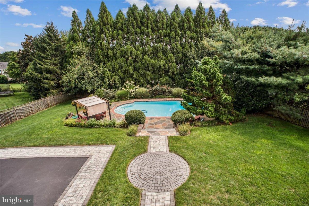 9917 Kendale Road Potomac, MD 20854 - Photo 3 of 39 a view of a wooden house with a yard and potted plants