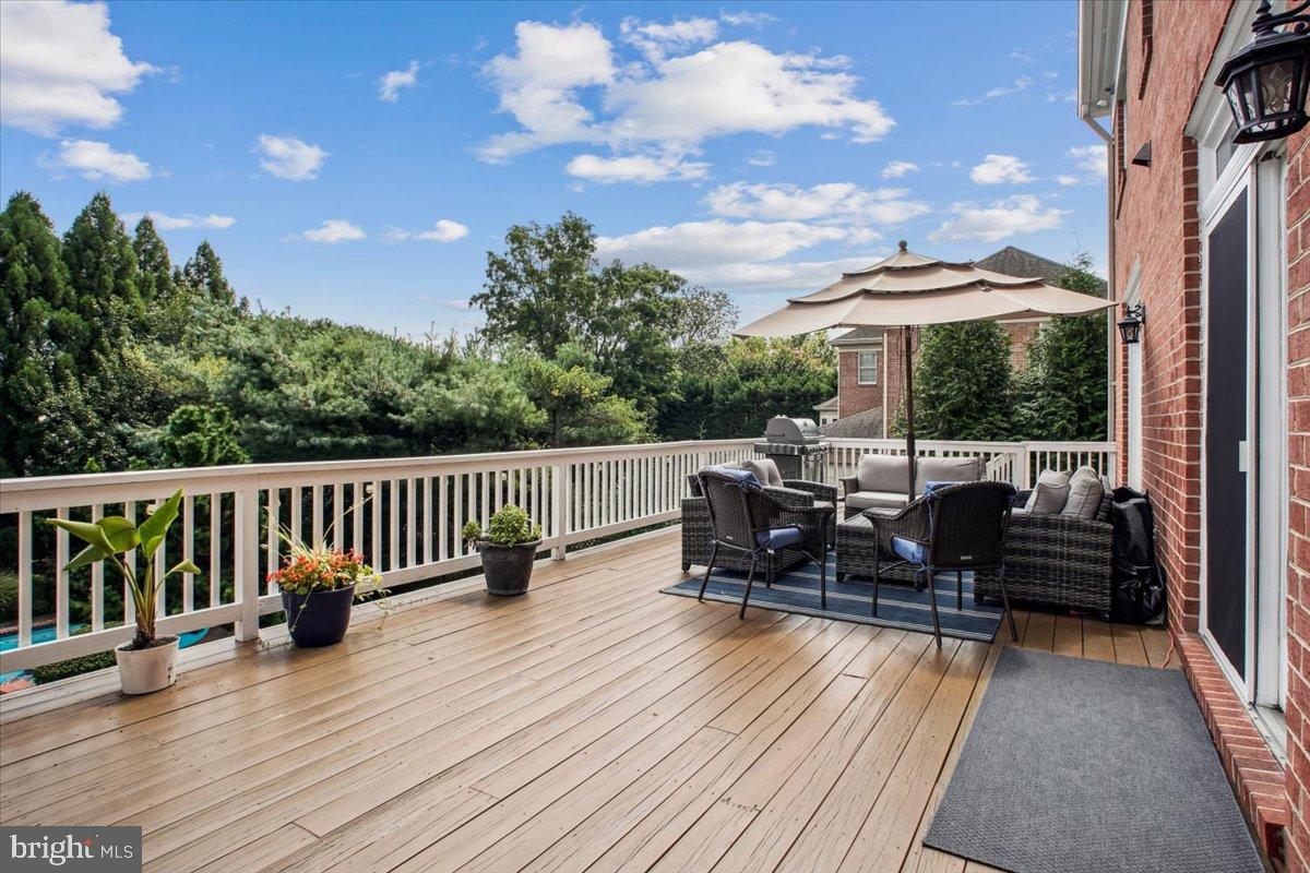 9917 Kendale Road Potomac, MD 20854 - Photo 31 of 39 a view of a balcony with chairs and wooden floor
