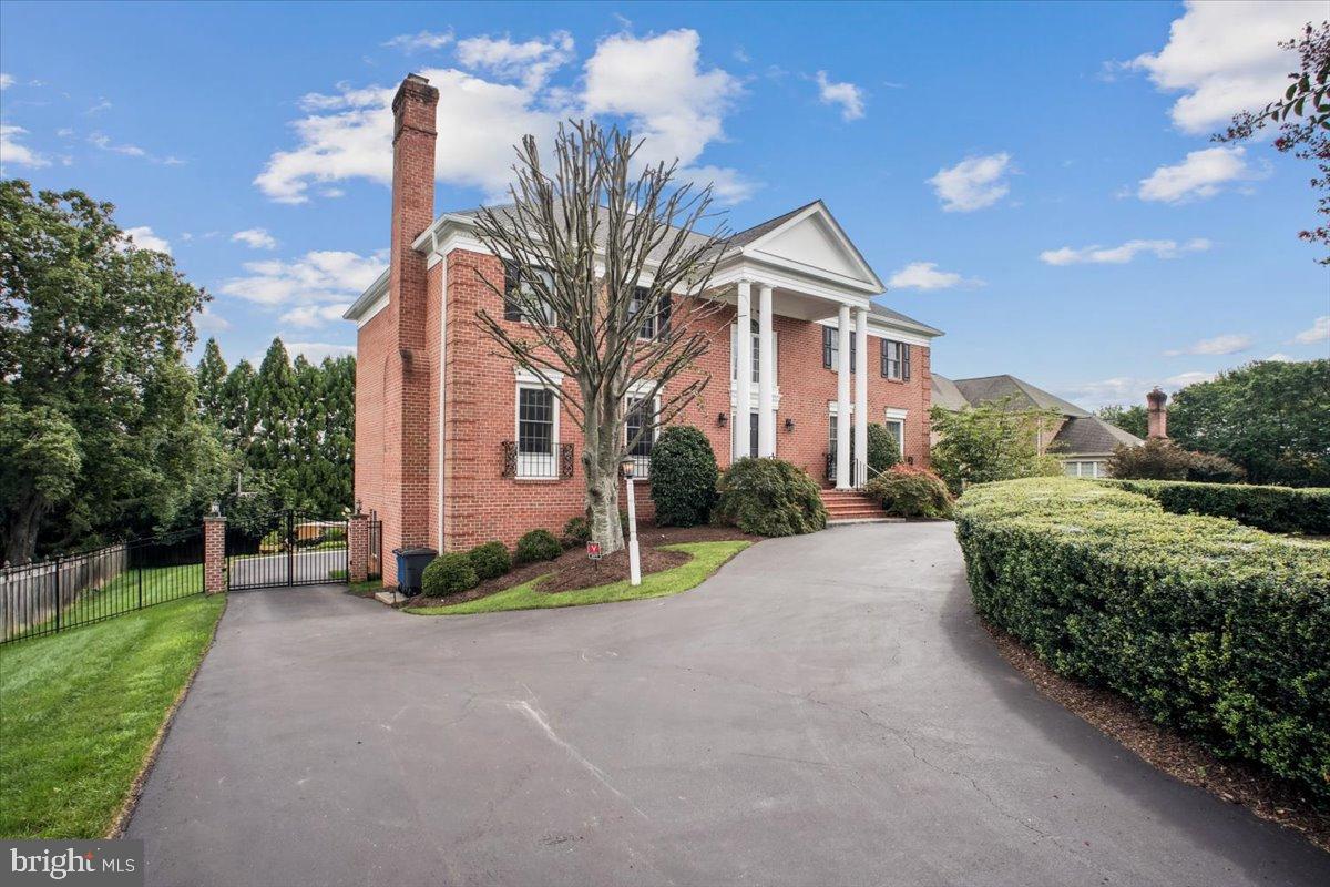 9917 Kendale Road Potomac, MD 20854 - Photo 36 of 39 a front view of a house with a yard and garage