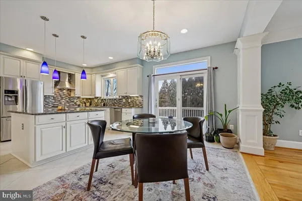a dining room with furniture potted plants and wooden floor
