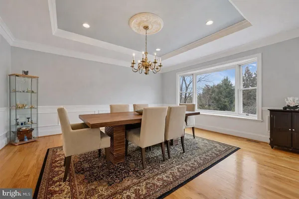 a dining room with furniture a rug and a chandelier