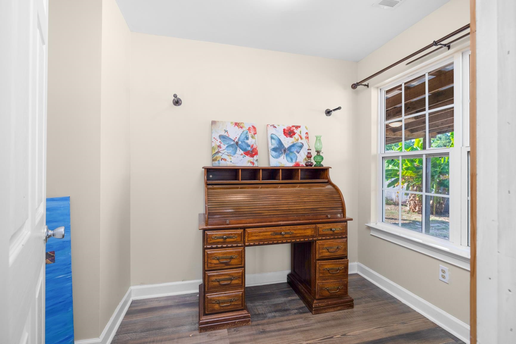 420 Sanford Road Covington, TN 38019 - Photo 13 of 27 Wood-finish flooring with white trim, light-toned wall paint, and a single window with white framing