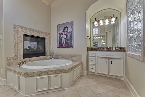 a spacious bathroom with a sink a large mirror and a bathtub