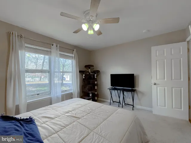 a bedroom with a bed and a tv on table