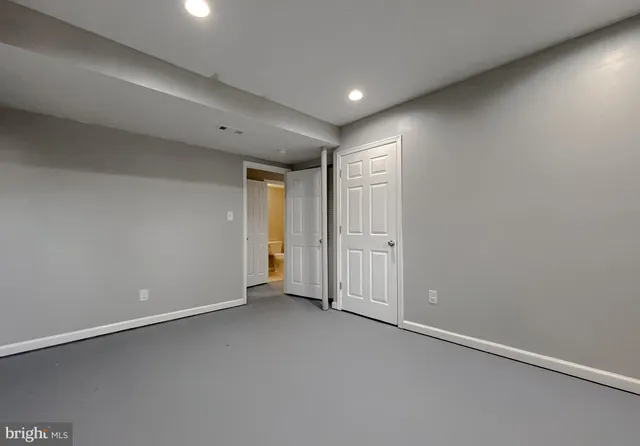 an empty room with windows and closet