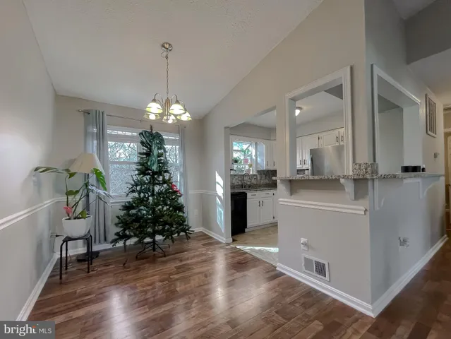 a view of a room with wooden floor and potted plant