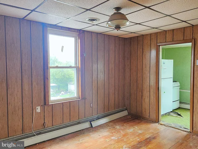 a view of an empty room with a bathroom and a window