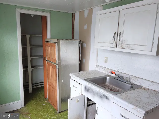 a kitchen with a refrigerator and a sink