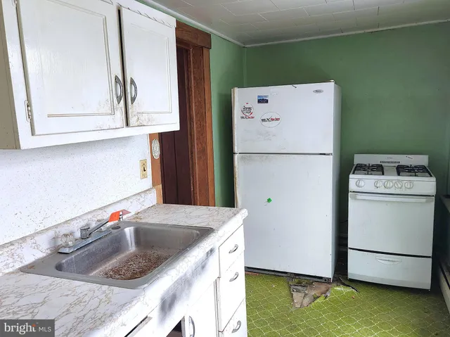a kitchen with a refrigerator sink and stove