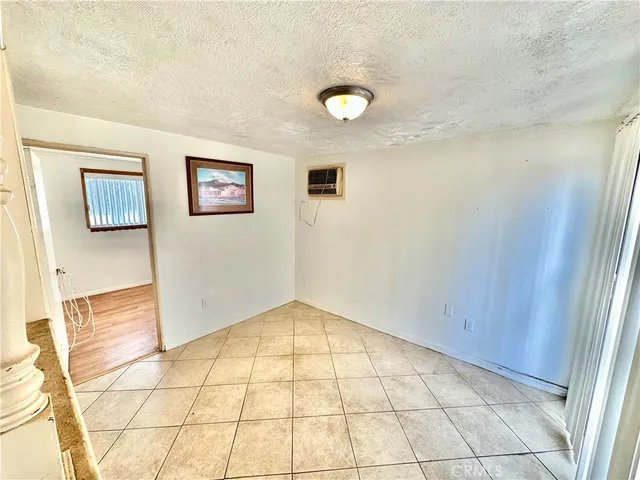 a view of a hallway with wooden floor and a living room