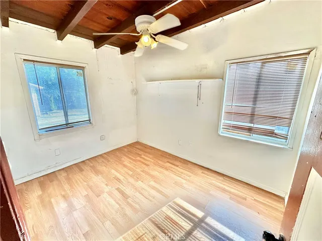 a view of a room with a wooden floor and a window