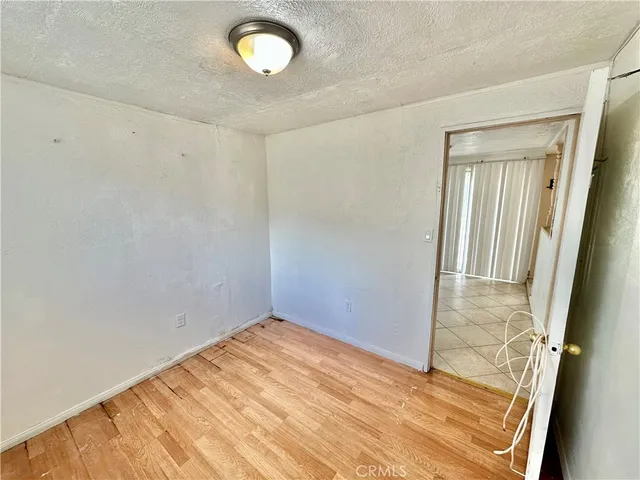 a yellow house with trees in front of it