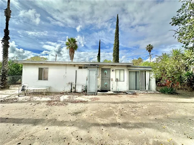 a view of a yard with plants and trees