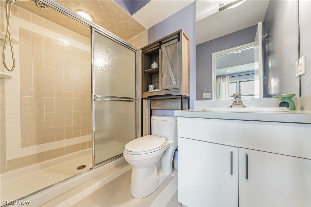3510 Hampton Road Pepper Pike, OH 44122 - Photo 18 of 31 Bathroom featuring tile floors, a shower with door, vanity, and toilet