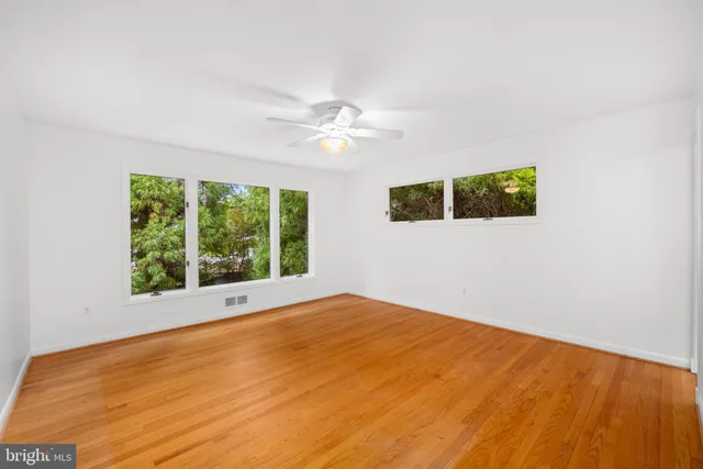 a view of an empty room with windows
