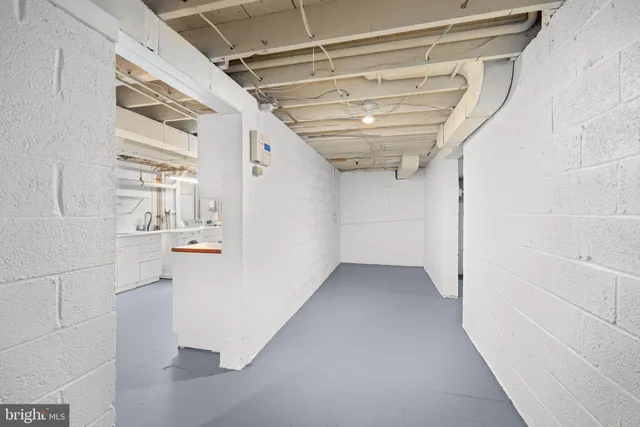 a kitchen with stainless steel appliances a sink and white cabinets