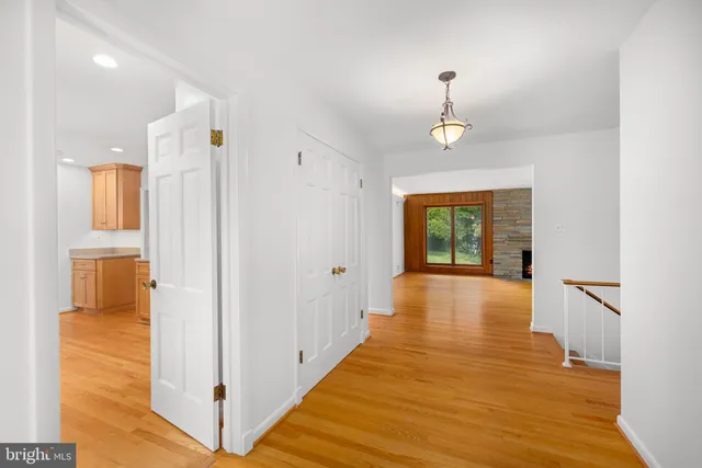 a view of a hallway with wooden floor and staircase
