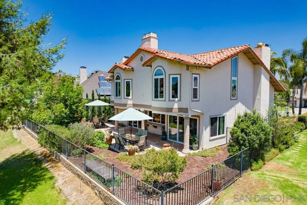 a front view of a house with yard and trees