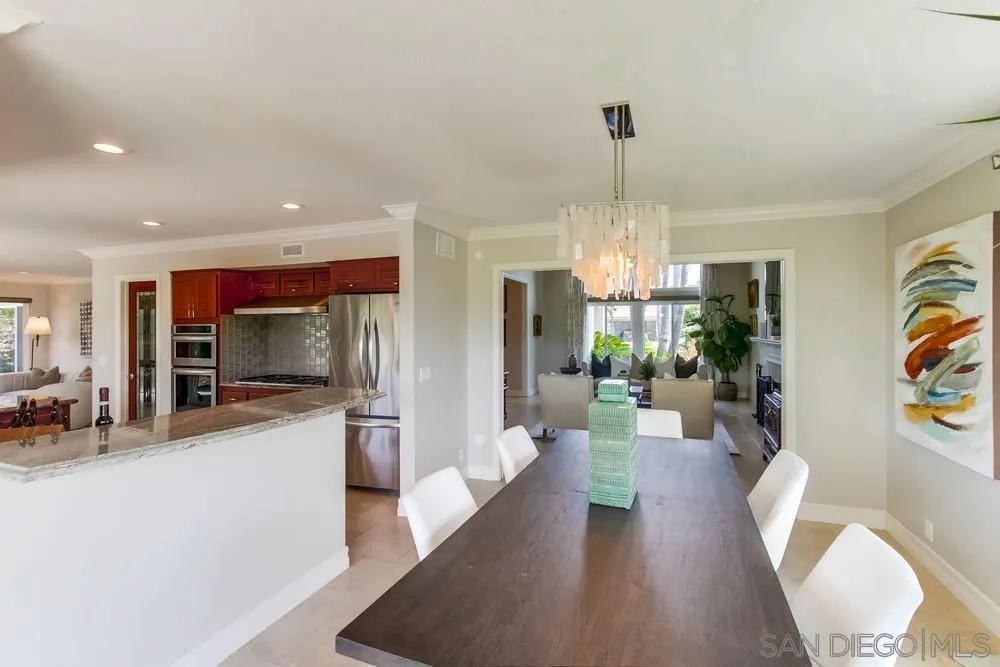 16101 Via Madera Circa West Rancho Santa Fe, CA 92091 - Photo 12 of 56 a view of a dining room with furniture a chandelier and wooden floor