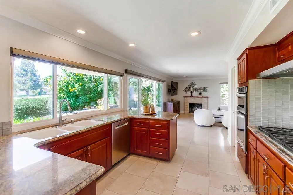 16101 Via Madera Circa West Rancho Santa Fe, CA 92091 - Photo 14 of 56 a large kitchen with stainless steel appliances granite countertop a stove and a sink