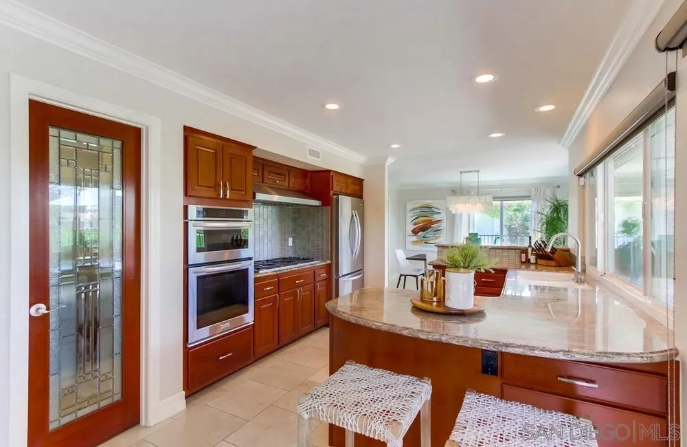 16101 Via Madera Circa West Rancho Santa Fe, CA 92091 - Photo 16 of 56 a kitchen with stainless steel appliances granite countertop a refrigerator and stove