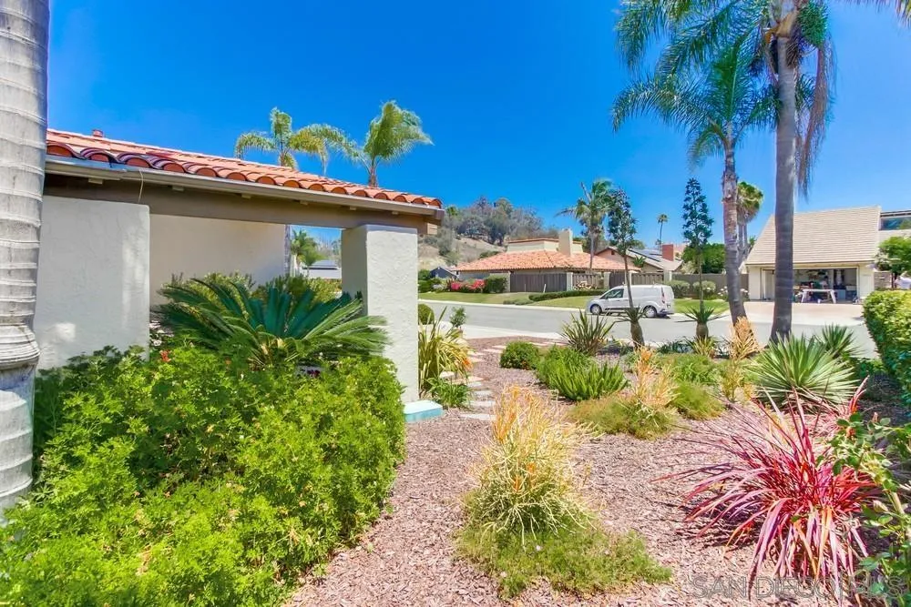 16101 Via Madera Circa West Rancho Santa Fe, CA 92091 - Photo 53 of 56 a front view of a house with a yard and potted plants