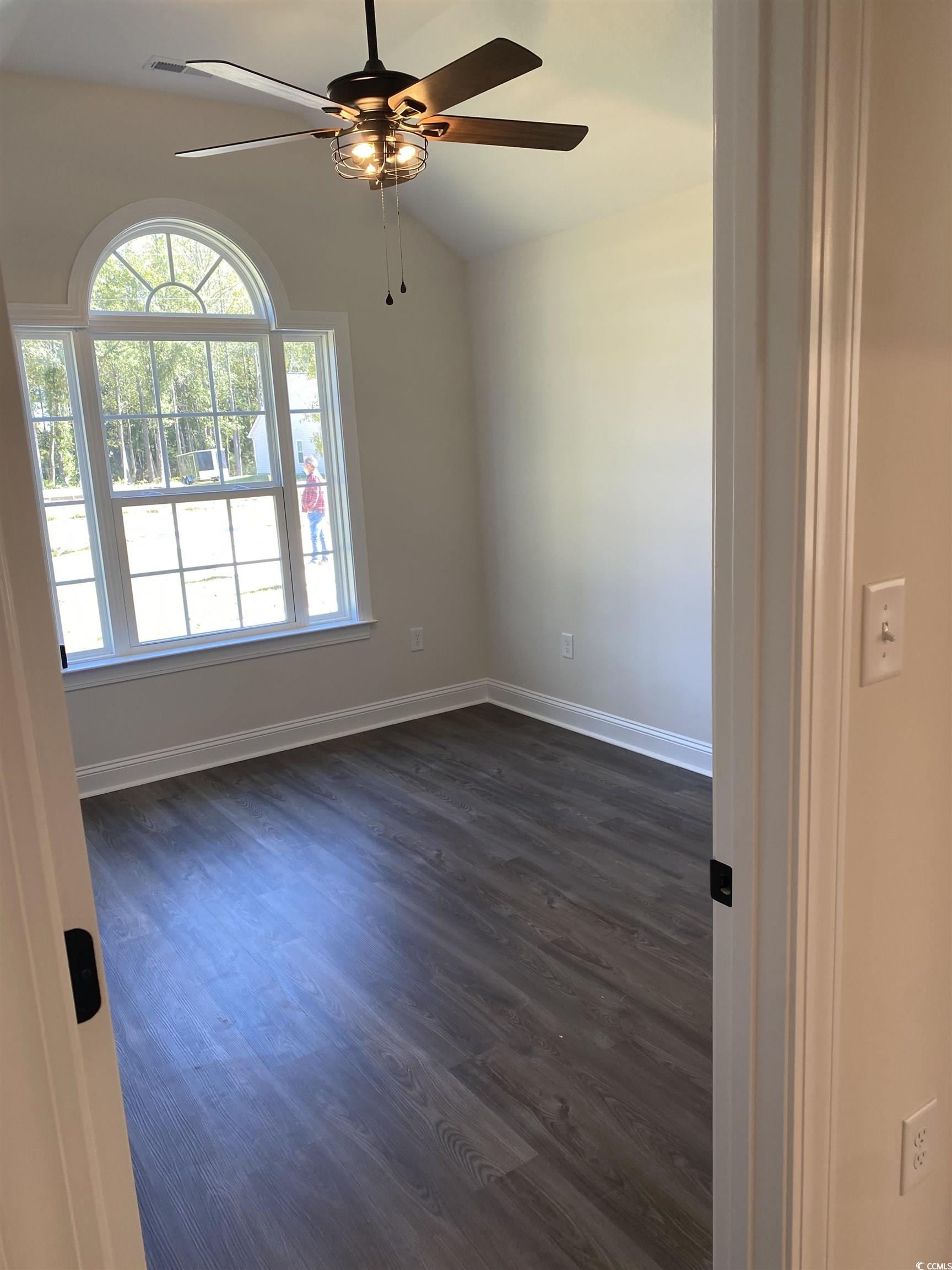 3397 Dusty Road Loris, SC 29569 - Photo 5 of 10 Empty room featuring vaulted ceiling, dark hardwoo