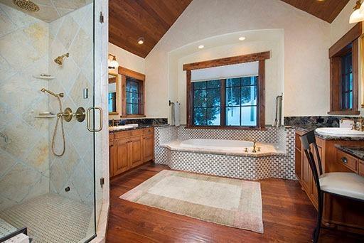 3618 Daybreak Ridge Road Avon, CO 81620 - Photo 13 of 14 a spacious bathroom with a granite countertop tub shower and mirror