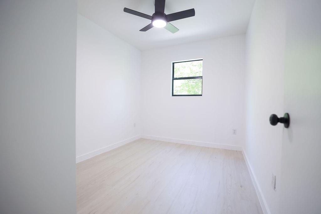 250 Skyview Point, TX 75472 - Photo 12 of 23 an empty room with a window and a fan