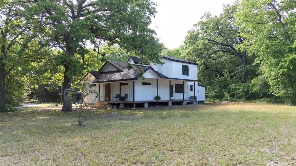 250 Skyview Point, TX 75472 - Photo 2 of 23 a house that has a tree in front of it