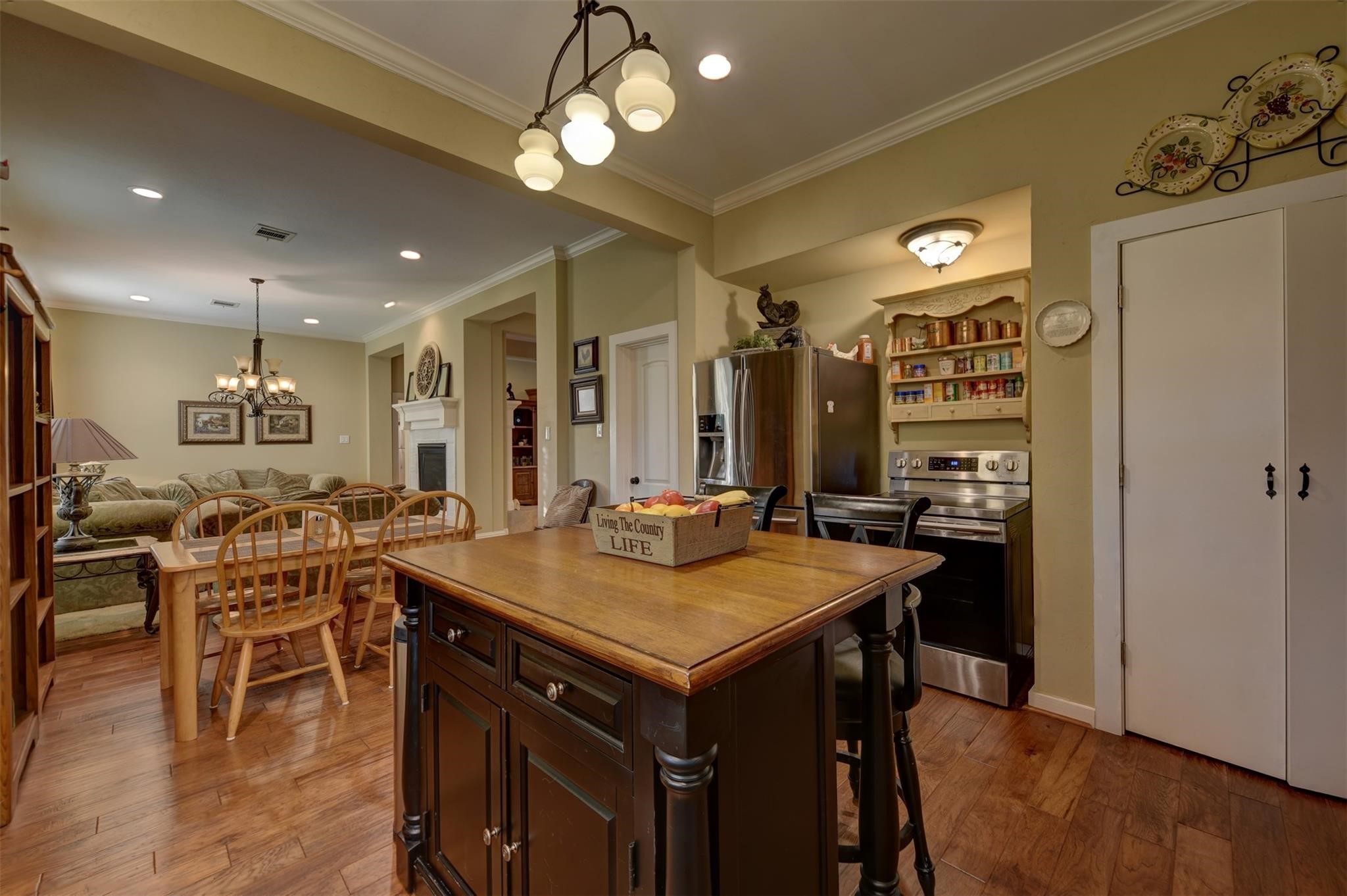 8456 Schuster Road Ledbetter, TX 78946 - Photo 12 of 49 a view of a dining room with furniture and wooden floor