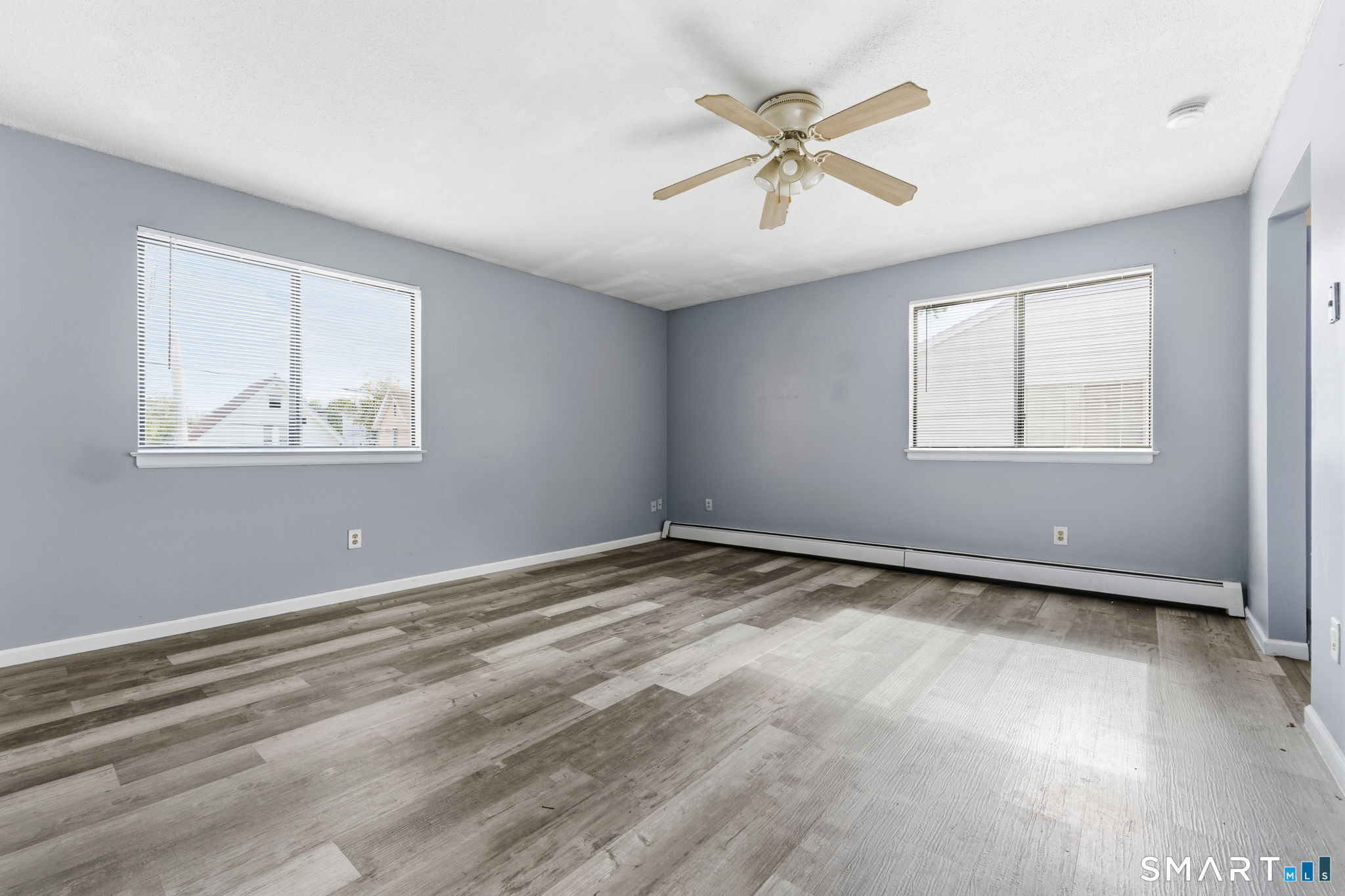 5-7 Warner St Extension, Unit 5B Hartford, CT 06114 - Photo 3 of 17 a view of an empty room with wooden floor and window
