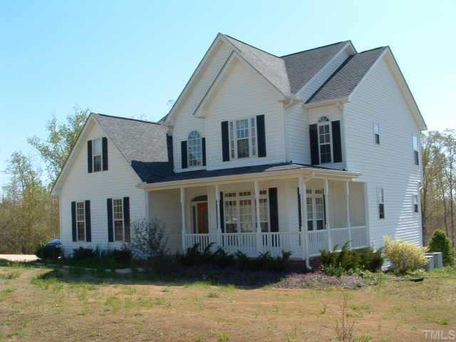1513 Red Brick Road Garner, NC 27529 - Photo 1 of 1 a view of a white house with large windows next to a yard