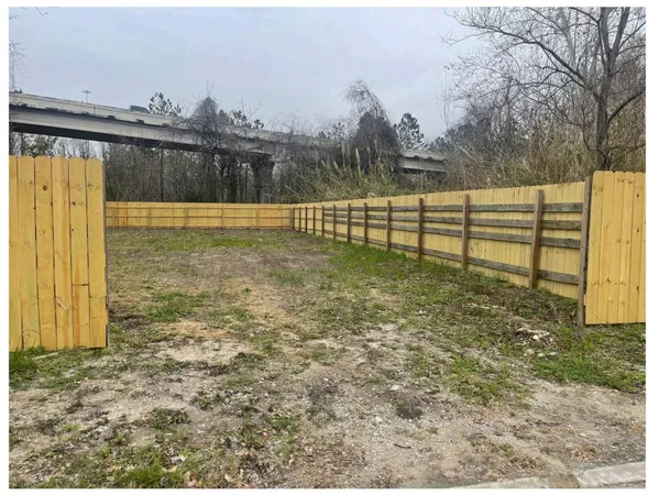 a view of a garden with large trees