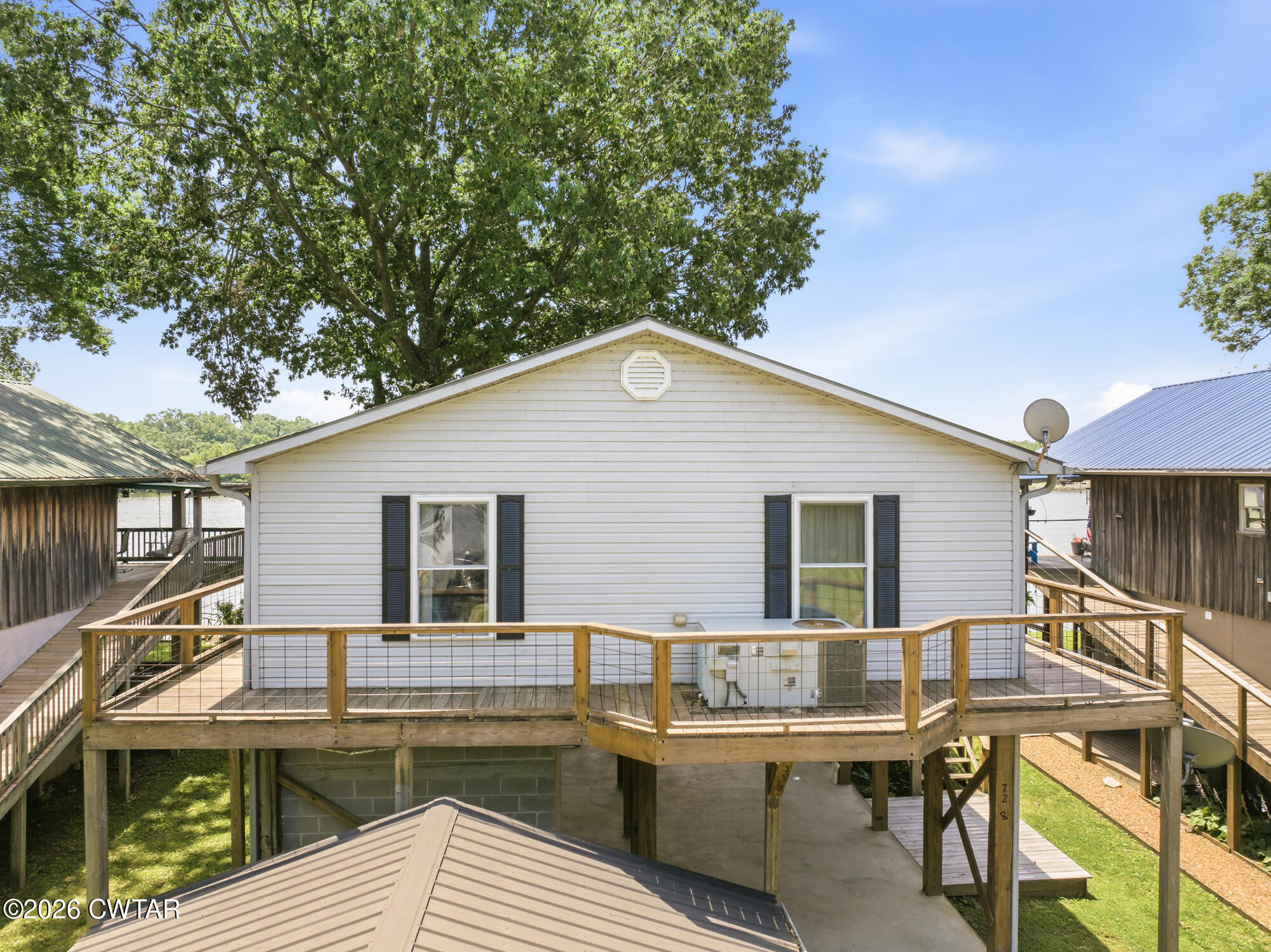 1728 Yarbro Landing Lane Decaturville, TN 38329 - Photo 24 of 44 a view of a house with wooden deck and furniture