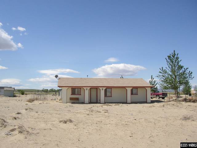 6135 Jacobs Road Fallon, NV 89406 - Photo 2 of 9 a front view of a house with a yard