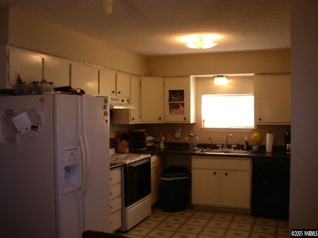 6135 Jacobs Road Fallon, NV 89406 - Photo 3 of 9 a kitchen with stainless steel appliances granite countertop a sink stove and refrigerator