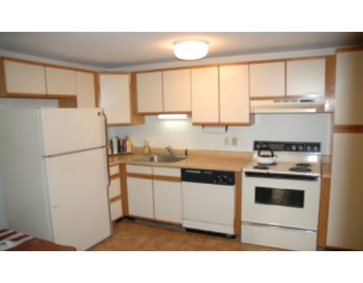 38 Leonard Road, Unit 38 Boxborough, MA 01719 - Photo 1 of 1 a kitchen with appliances a sink and a refrigerator