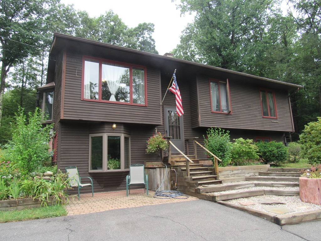 135 Fomer Road Southampton, MA 01073 - Photo 1 of 19 a front view of a house with a garden