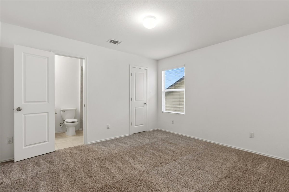 101 Rowdy Yates Way Jarrell, TX 76537 - Photo 25 of 32 Carpeted interior room with white walls, a single window, and a ceiling-mounted light fixture