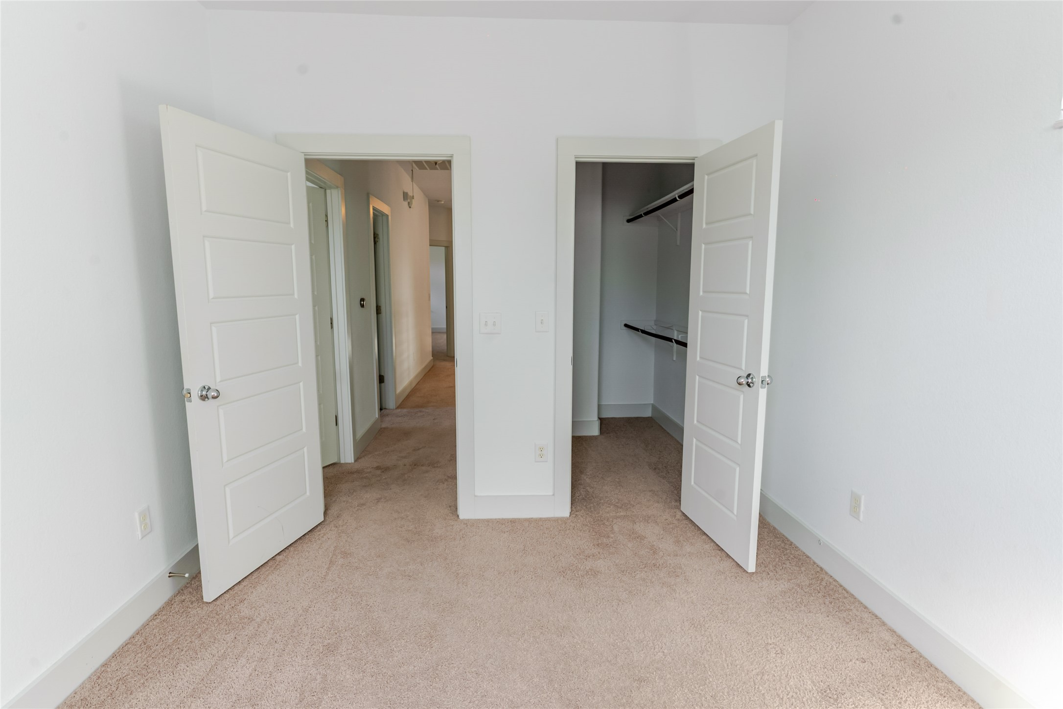 1400 Homespun Road Austin, TX 78745 - Photo 22 of 30 Plush carpeting and crisp white trim enhance this functional bedroom space with closet storage.