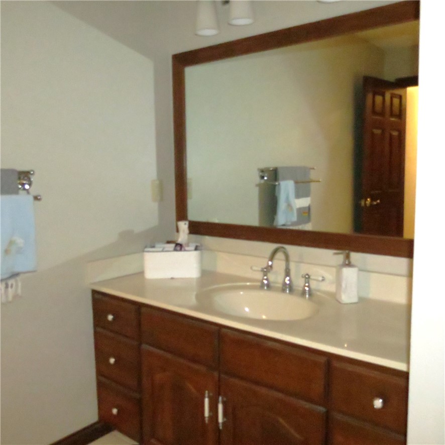 10160 Lochard Road Sidney, OH 45365 - Photo 29 of 41 This clean and inviting bathroom features a single vanity with ample storage and a large mirror.