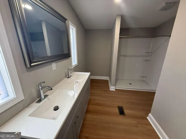 a bathroom with a tub sink and mirror