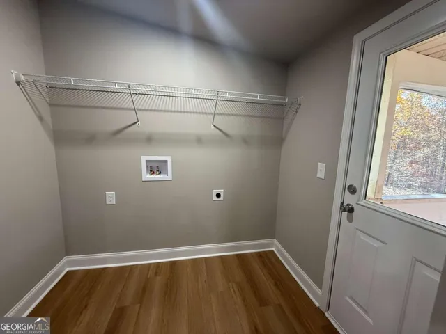 a view of a room with wooden floor and windows